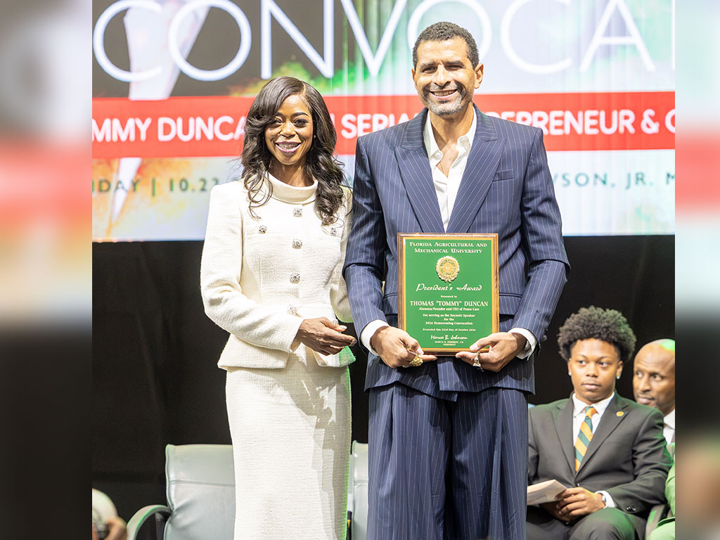 FAMU President Marva B. Johnson, J.D., presents keynote speaker and alumnus Thomas “Tommy” Duncan with the President's Award during the university's 2026 Homecoming Convocation on Friday, Oct. 23. (Photo by Jeff Adams/FAMU)