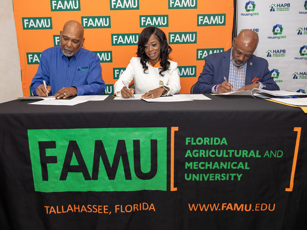 Robinson, Johnson and Rawls at the cermonial signing