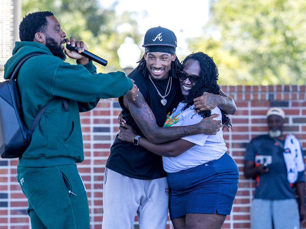 A FAMU student shares a joyful embrace with a family member during Parents and Family Weekend 2026, highlighting the family connections at the heart of the Rattler community.