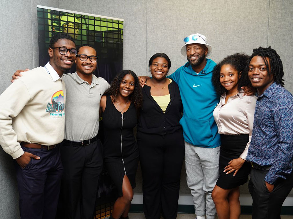 Comedian and radio personality Rickey Smiley, third from right, poses for a photo with a group at WANM 90.5 FM, Florida A&M University’s student-run radio station. (Photo courtesy of WANM 90.5 FM)