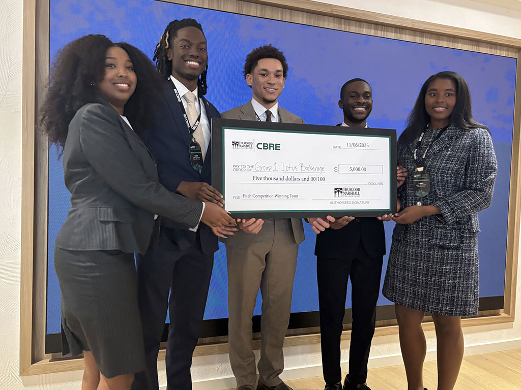 Participants celebrate their $5,000 award from CBRE during a Thurgood Marshall College Fund pitch competition. The winning team, Lotus Brokerage, was recognized for its presentation and innovative business proposal.
