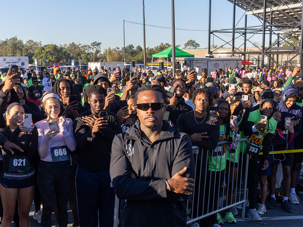 Atlanta rapper Gunna stands in front of a crowd of enthusiastic runners and supporters during the fifth annual Walmart-sponsored FAMU Homecoming 5K Run/Walk on Thursday, Oct. 22, 2026, at Bragg Memorial Stadium. The event featured a special collaboration with Gunna's Wunna Run Club and drew more than 850 participants.  Photo courtesy of Jeff Adams.