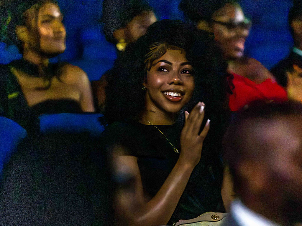 Sanai McKinney, a College of Science and Technology student from Memphis, Tennessee, smiles and applauds as she watches FAMU’s episode of “The College Tour” during the premiere screening at Lee Hall Auditorium. Photo courtesy: Jeff Adams, FAMU University Photographer.