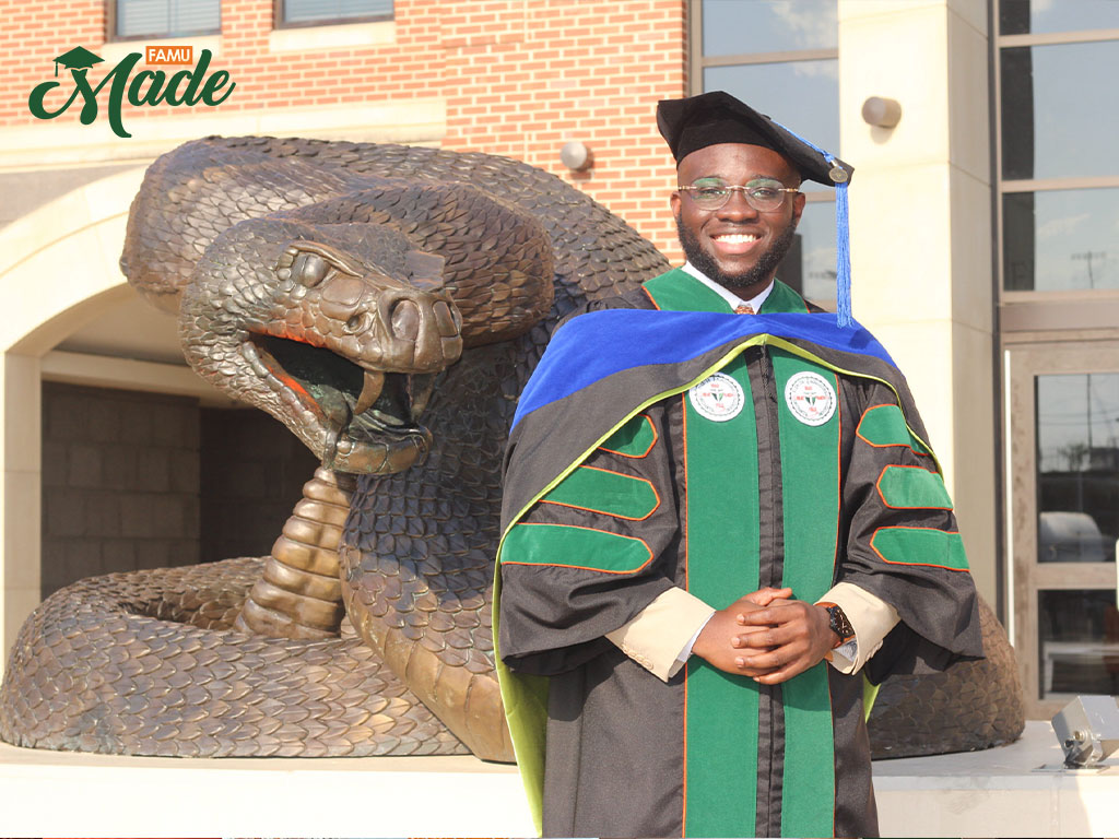 Recent FAMU Graduate Poses in Front of Giant Rattler