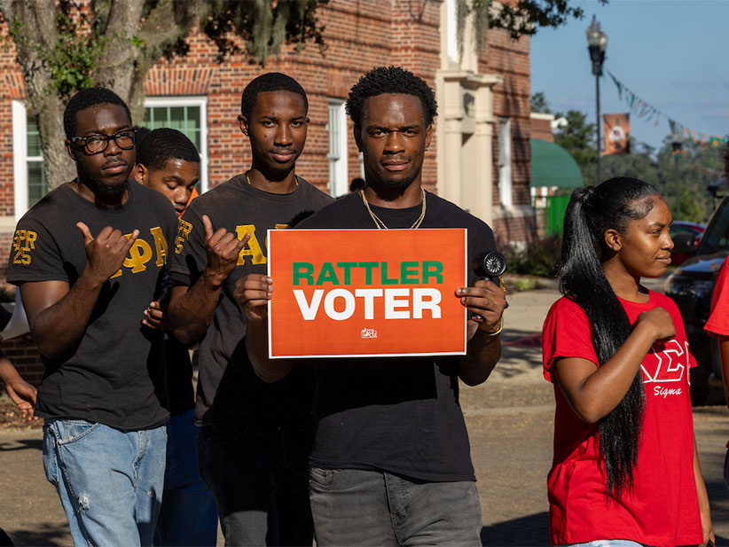 Alphas holding Rattler vote sign