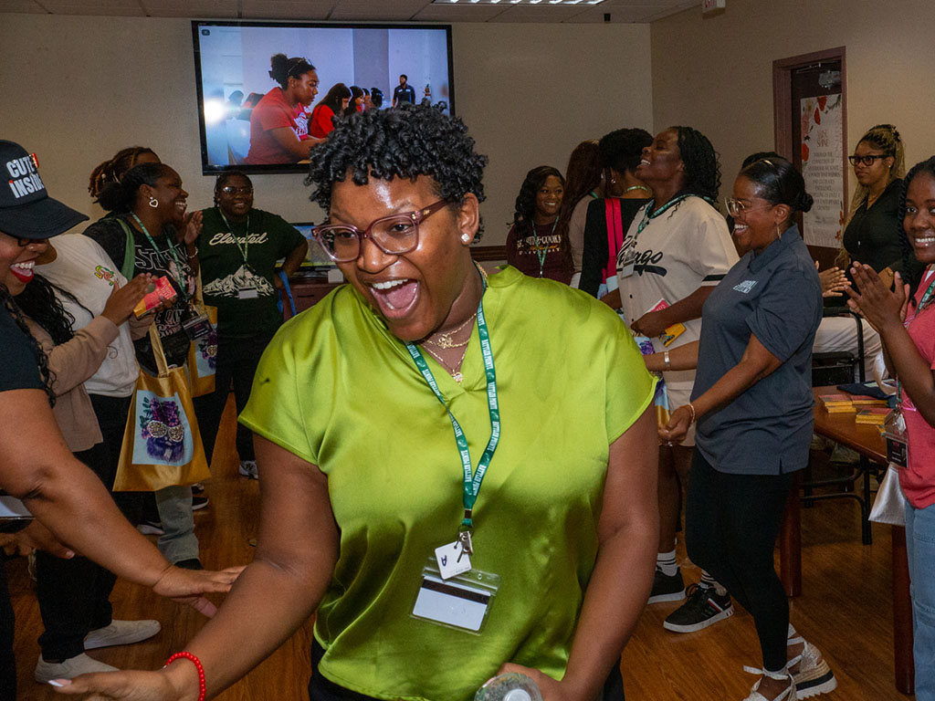 Smiles and greetings fill the air as participants make their way through the welcome line to kick off the summit