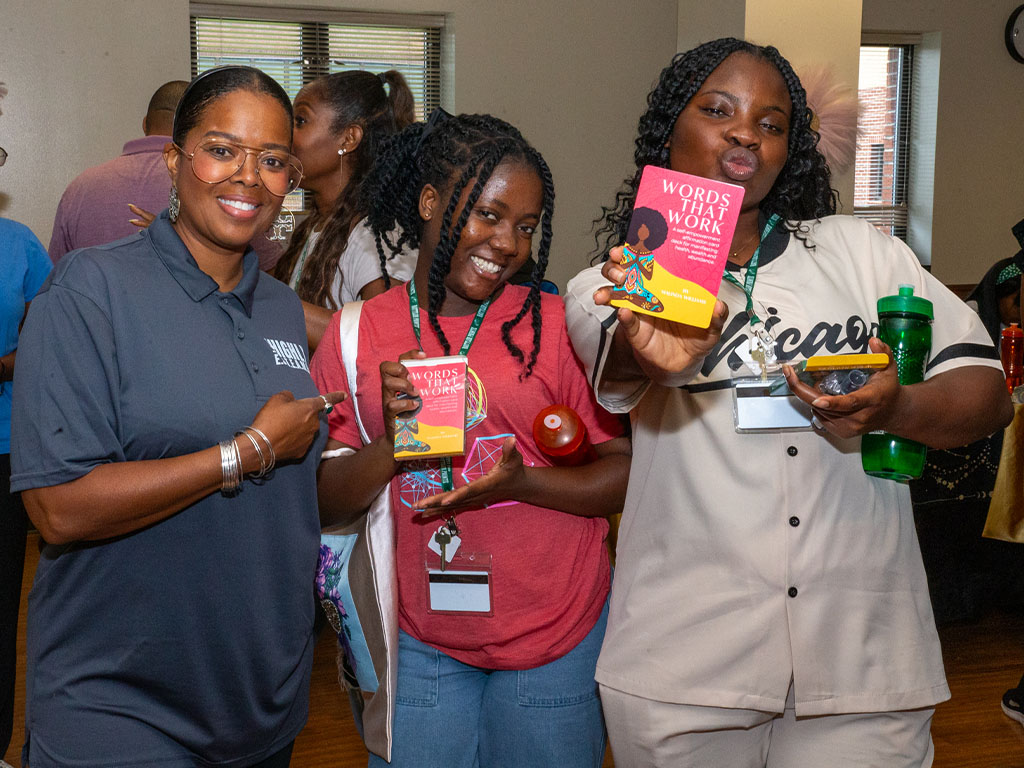 Malinda Williams snaps a photo with participants as she shares her signature affirmation cards.