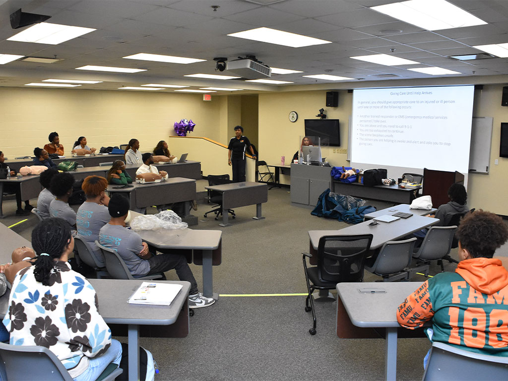 Students gather in a classroom at Florida A&M University for CPR certification instruction during a Black Men in Medicine event designed to teach life-saving emergency response skills.