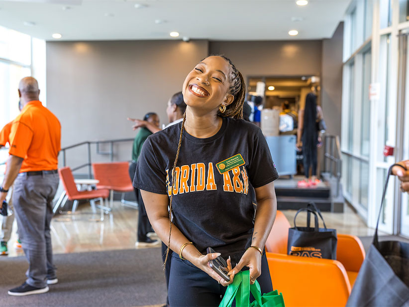 A resident assistant flashes a big smiles