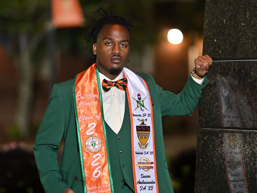 Da’Mari Clayton poses on campus in his graduation regalia, marking the culmination of his journey at Florida A&M University. (Photo Courtesy: Da’Mari Clayton)