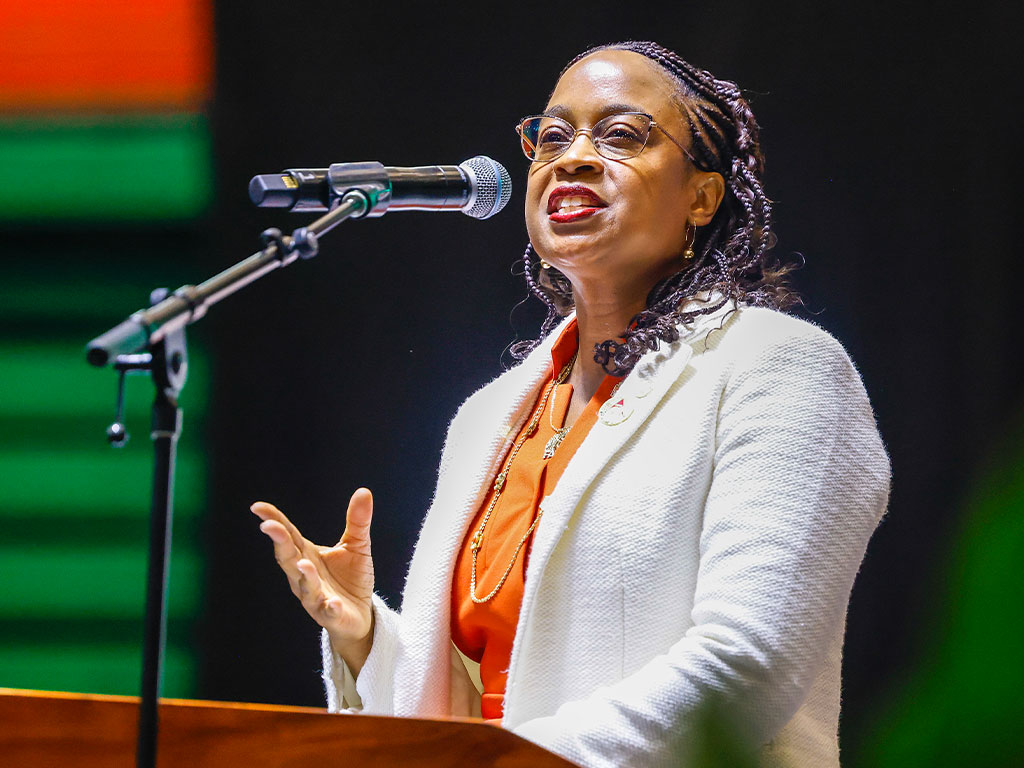 FAMU NAA President Artisha R. Polk addresses the crowd during her first Homecoming Convocation, inspiring students and alumni alike.