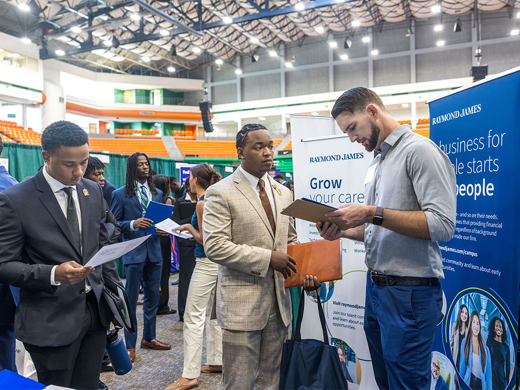 Florida A&M University students explore career opportunities with a Raymond James recruiter during the Fall 2026 Career and Internship Expo. The event featured 96 registered employers offering students opportunities to learn about internships, full-time positions and career pathways. (Photo courtesy of Jeff Adams.)