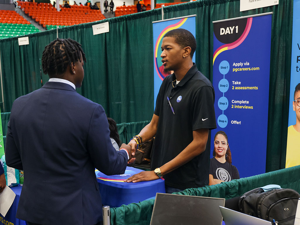 A Florida A&M University student connects with a recruiter during a networking opportunity, exchanging a handshake that could mark the beginning of a future career path.