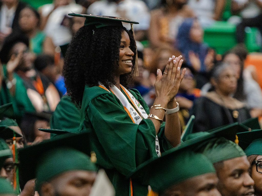 Taylor Whittley applauds during Florida A&M University's Summer 2026 Commencement Ceremony at the Alfred Lawson Multipurpose Center and Teaching Gymnasium. Her father, FAMU alumnus and commencement speaker Tirrell D. Whittley, delivered an address centered on "Full Circle Moments," a theme made especially meaningful as he watched his youngest daughter earn her degree. (Photo courtesy of Michael Cork.)