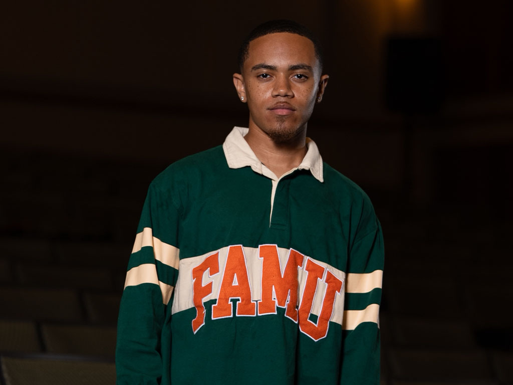 Dakarai Williams poses inside Tucker Hall, the academic building that shaped his journey as a psychology major at Florida A&M University.