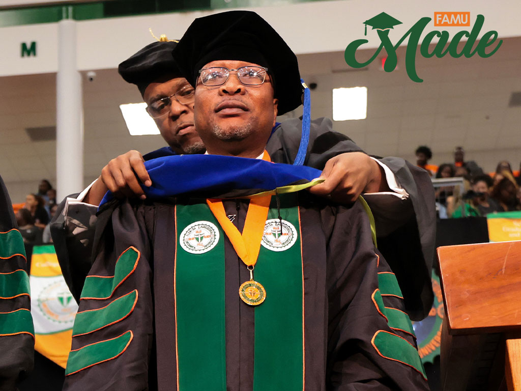 Graduate appears emotional as he is hooded