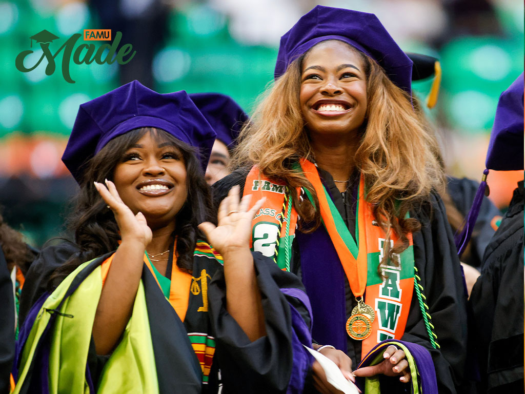 Two FAMU grads smiling