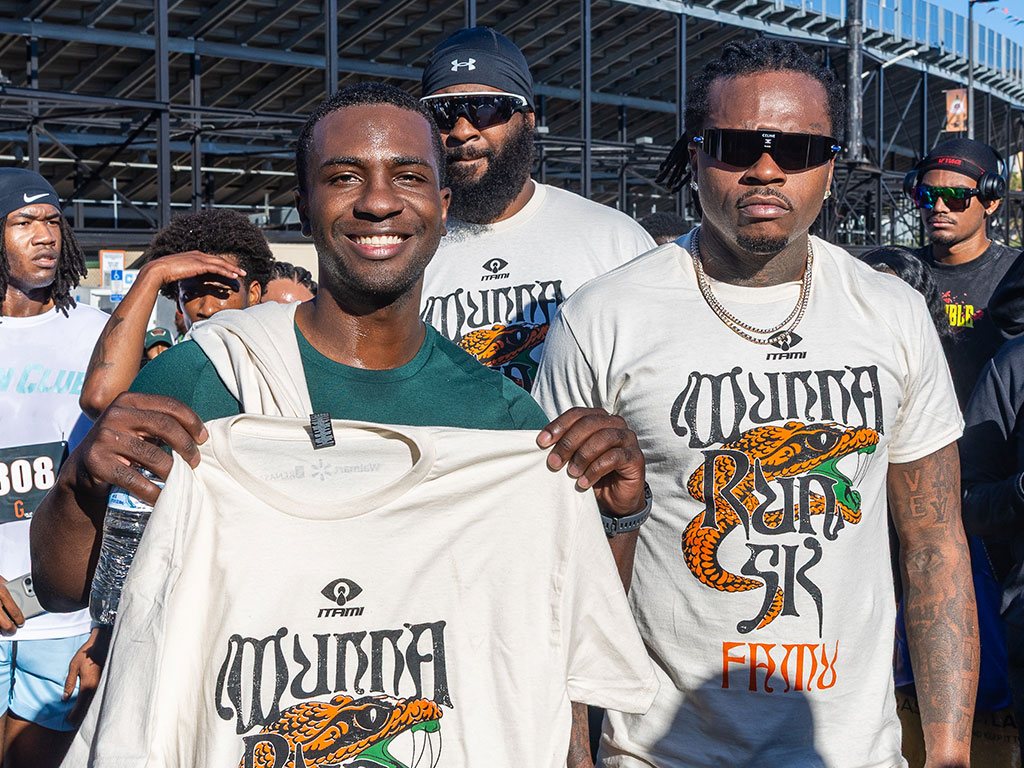 Mister FAMU Evan Lesure (left), the first-place male finisher of the 2026 FAMU Homecoming 5K, poses with Atlanta rapper Gunna (right) while displaying Wunna Run Club merchandise during the fifth annual Walmart-sponsored event on Thursday, Oct. 22, at Bragg Memorial Stadium.  Photo courtesy of Jeff Adams.