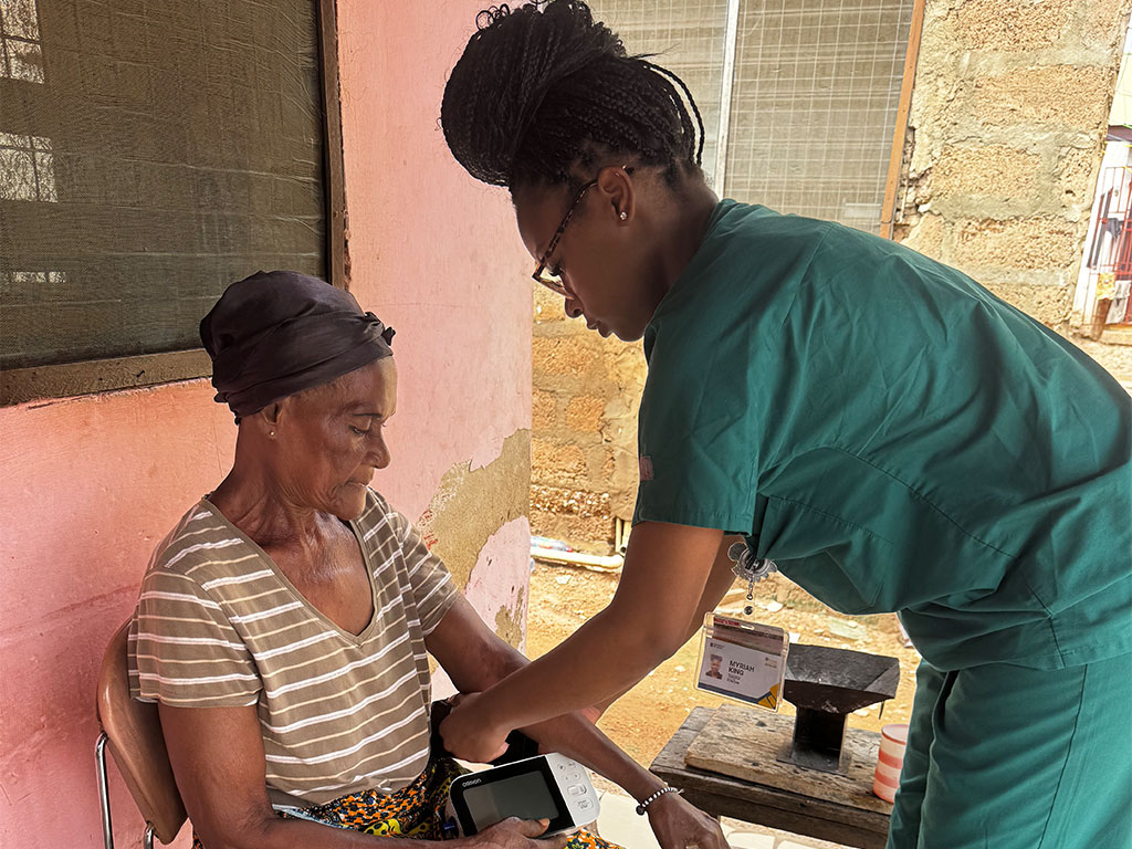 FAMU nursing student checking the blood pressure for a local Ghanian