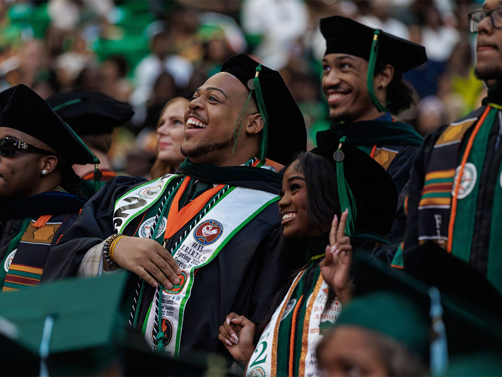 Spring 2026 graduates laughing