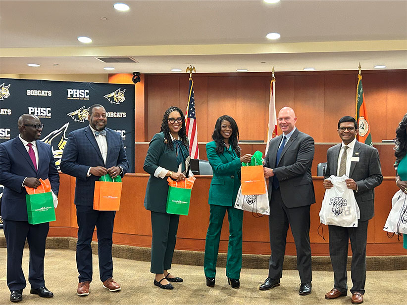 FAMU and Pasco-Hernando Administrators exchange gifts.