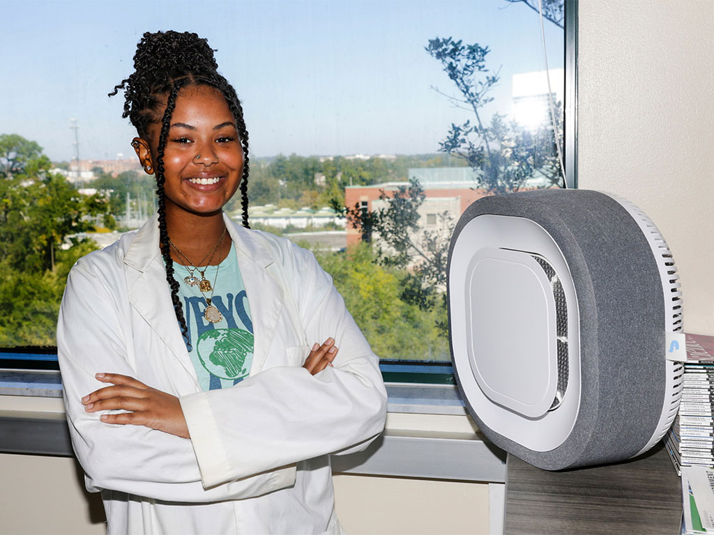 A Florida A&M University School of the Environment student demonstrates one of the air quality sensors used to monitor environmental conditions in real time. The sensors collect data on temperature, humidity, particulate matter and other air quality indicators that support research related to hurricane preparedness and campus resilience. (Photo courtesy of Florida A&M University.)