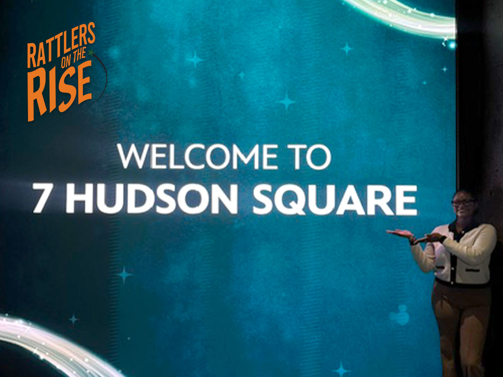 Hannah poses infront of 7 Hudson Square sign