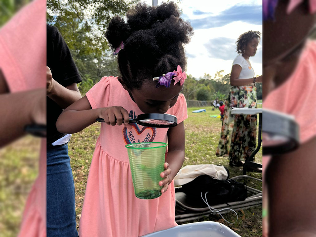 A young future farmer taking a look at the earth.