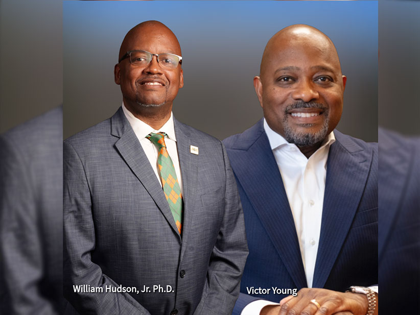 A professional headshot of Dr. William Hudson Jr., vice president for Student Affairs and Board Trustee Victor Young