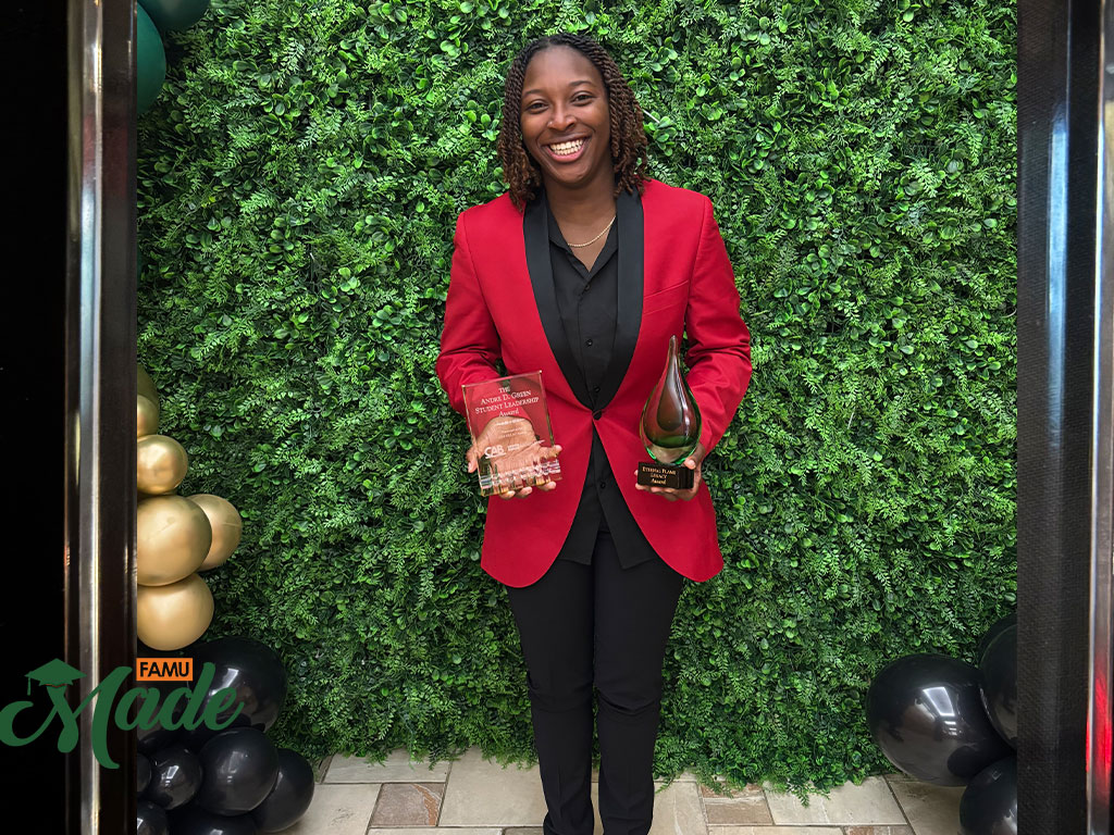 Aniyah Anderson-Cooper holding two huge awards she earned during her time at FAMU