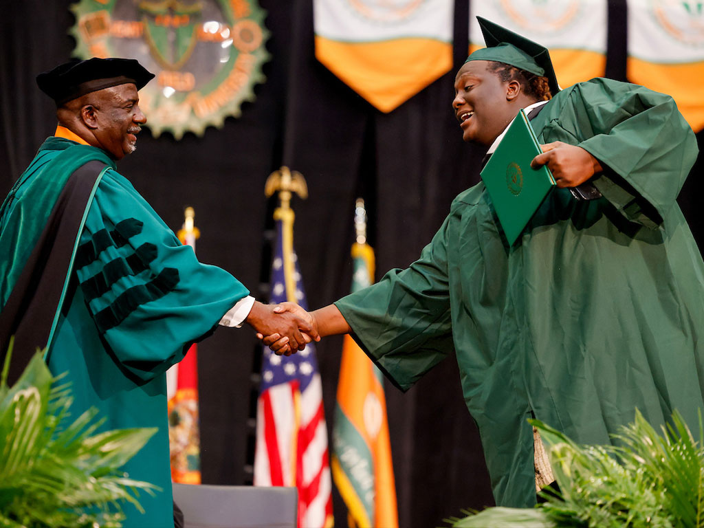 Interim President Beard and Graduate Handshake
