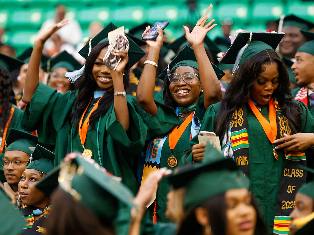 Trio of lady graduates smiling for the camera