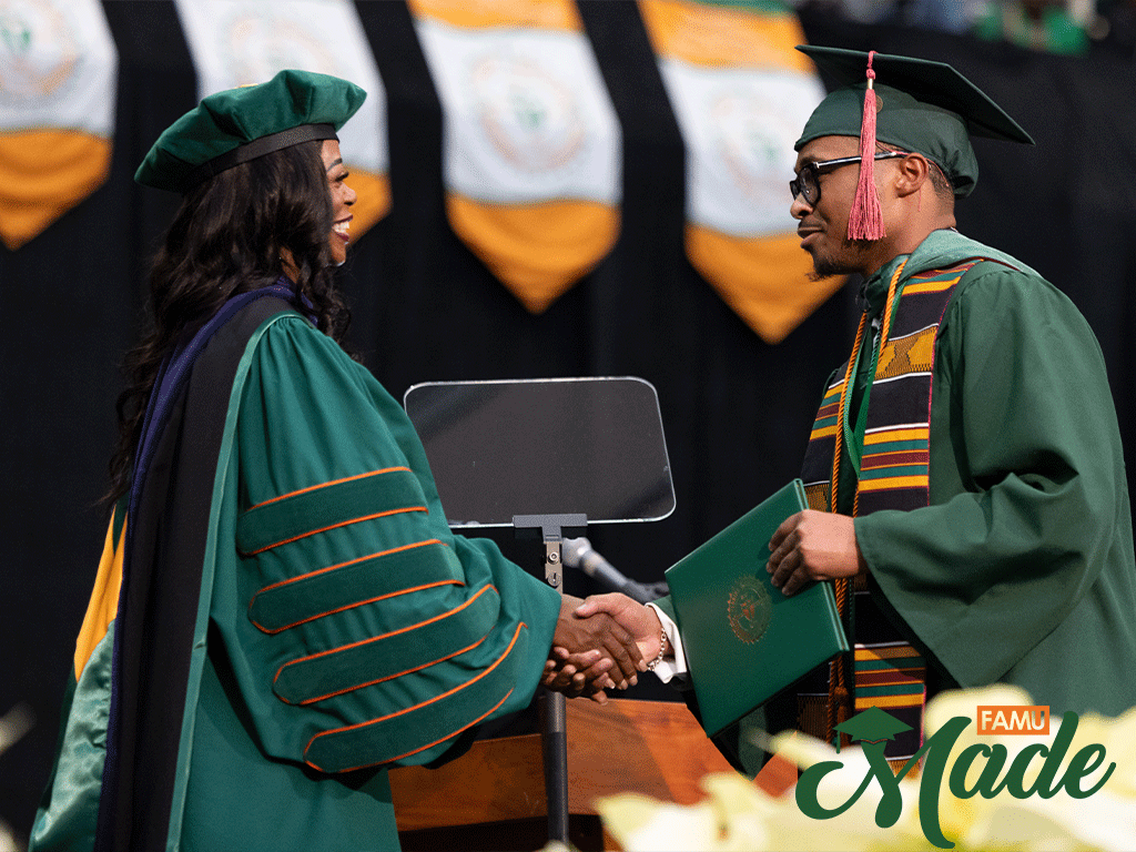 Jefferey Hood Jr. shaking President Johnson's hand during commencement.
