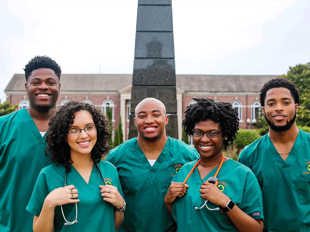 FAMU nursing students standing in front of the eternal flame. 
