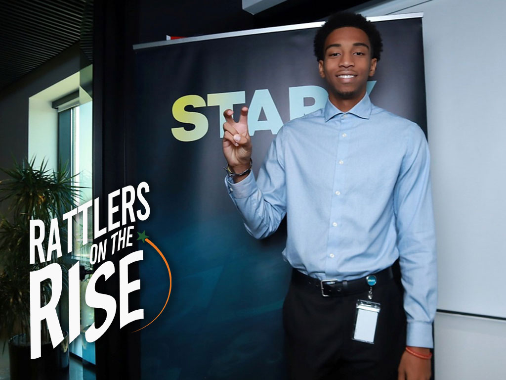 Chiyle Briggins does the Rattler Fang pose infront of STARZ sign