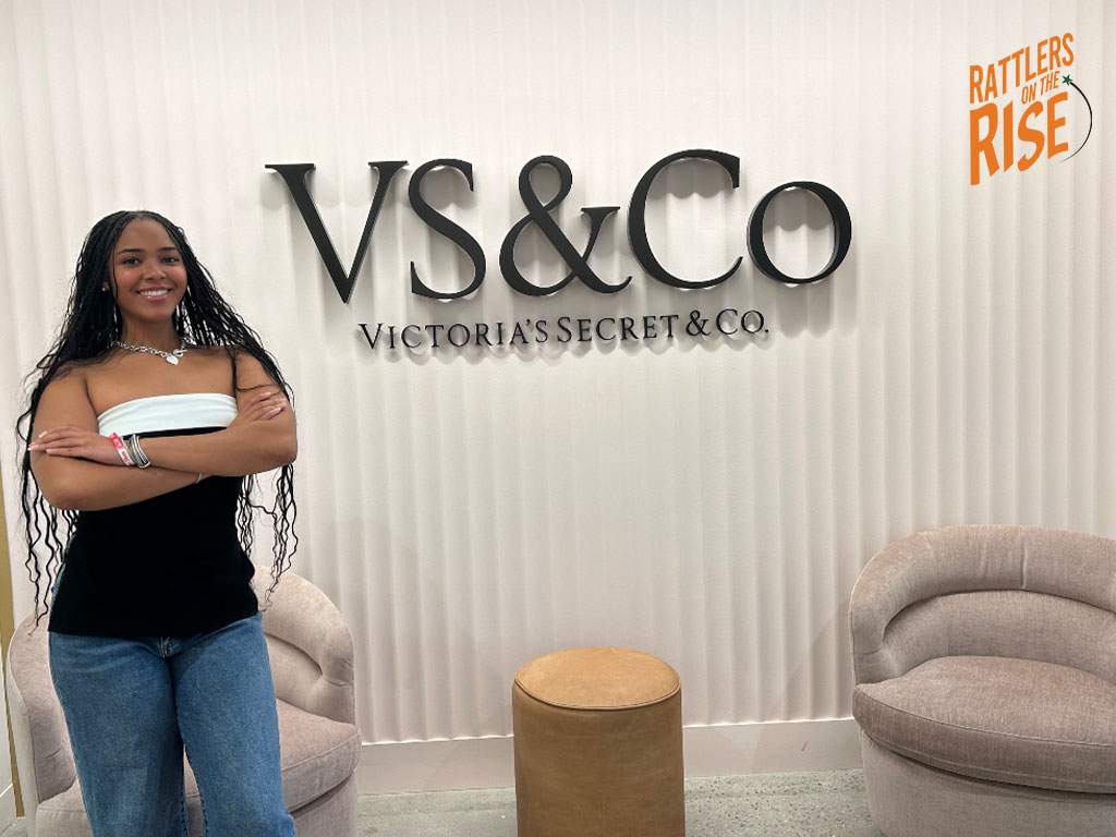 Chailyn poses infront of VS&CO Sign 
