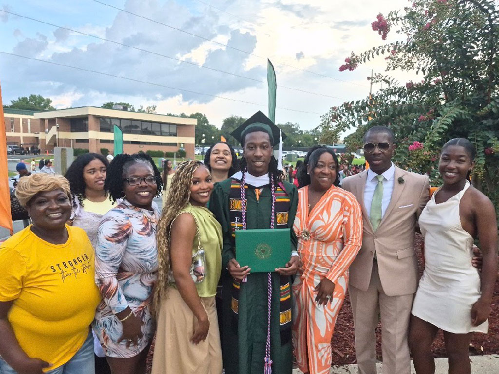 Jayden “JB” Patterson celebrates earning his degree from Florida A&M University surrounded by family and loved ones. His graduation marked the culmination of a FAMU journey that included three years representing the university as Venom. Photo courtesy of Jayden Patterson