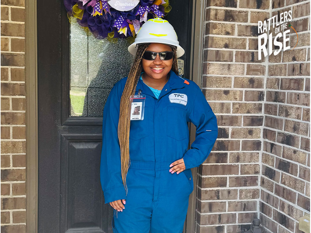 Jaylyn Smith stands infront of one of her internship projects