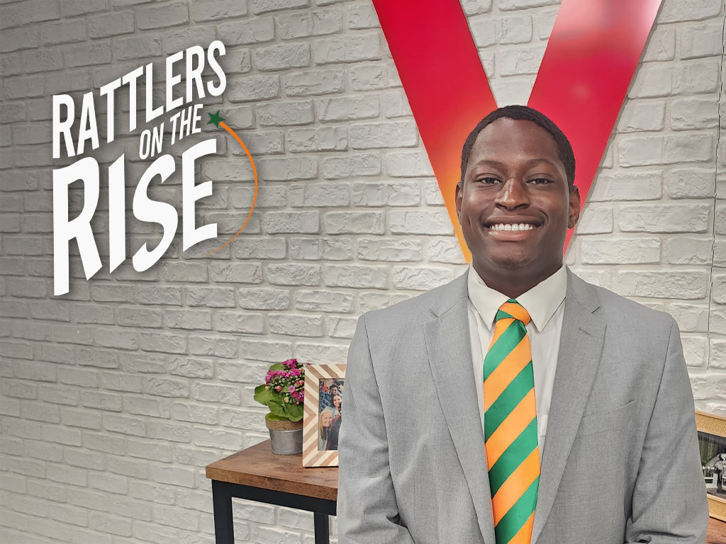 Jeremiah poses in front of Verizon sign for his internship