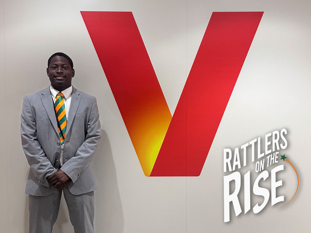 Jeremiah strikes his Rattler pose in front of the Verizon sign, proudly representing FAMU during his summer internship.
