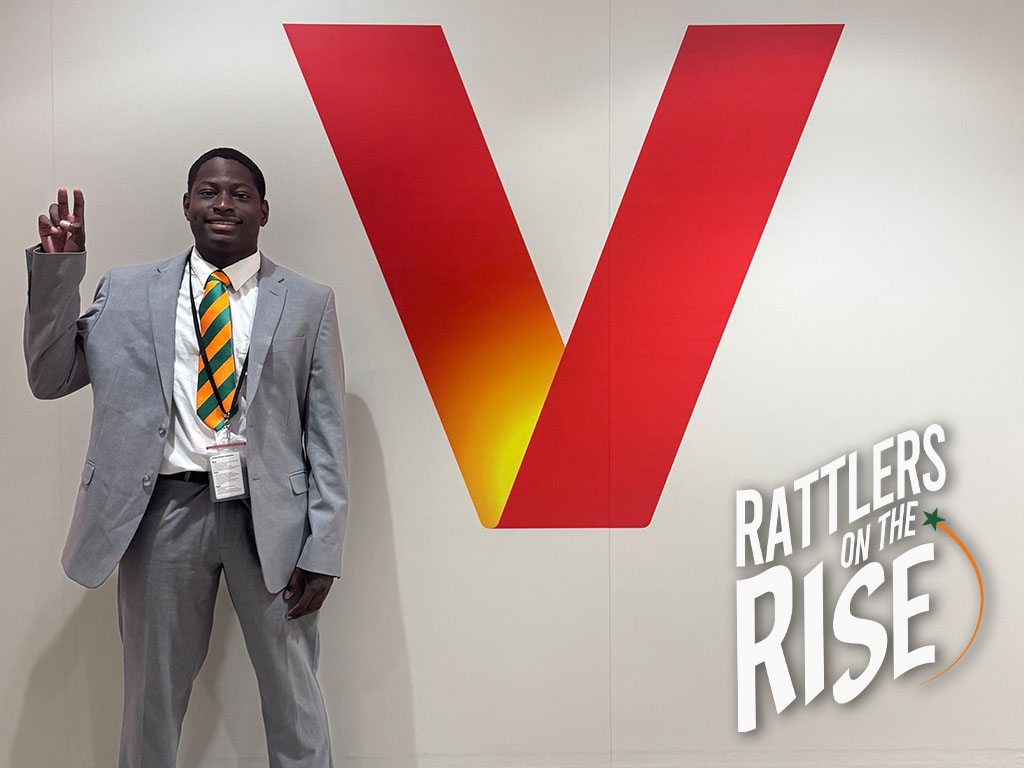 Jeremiah poses in front of Verizon Sign with his rattler strike