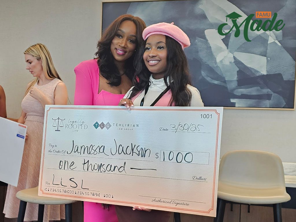 Jamesia Jackson with a scholarship big check
