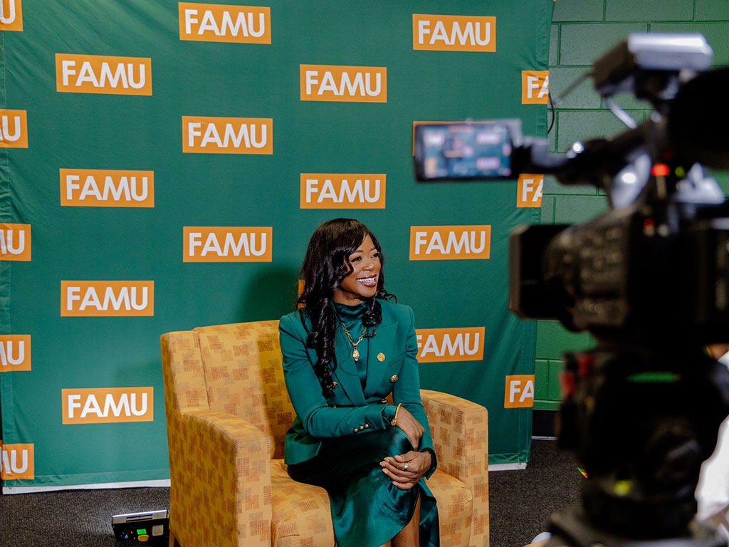President Johnson smiling in front of television camera.