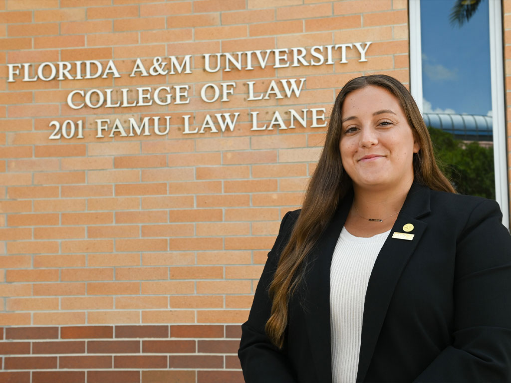 FAMU College of Law's Kayla Carestia posed in front of the FAMU COL signage