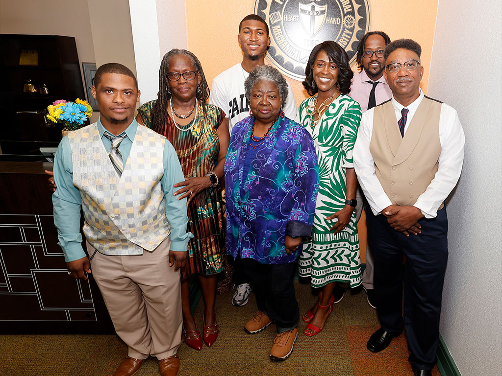 Kurt Adams pictured with his family in the president's office.