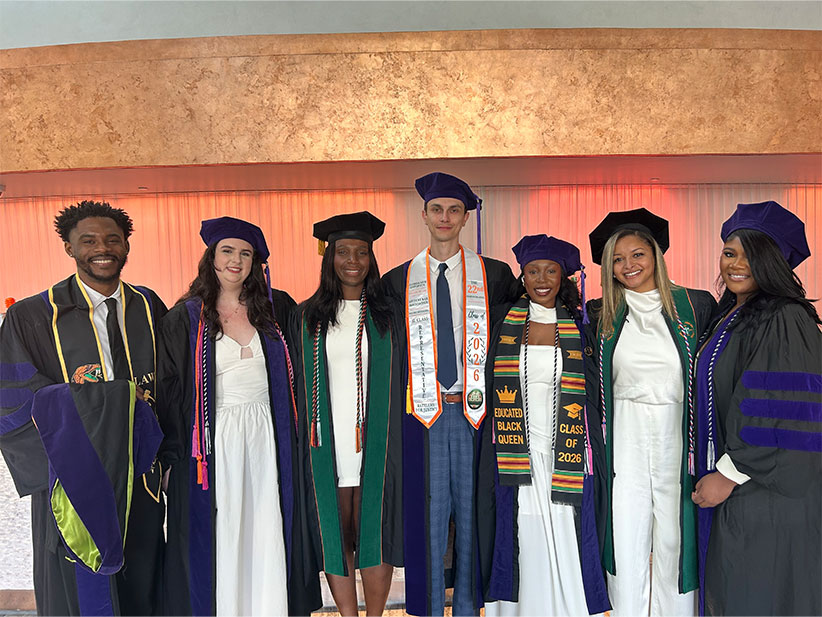 College of Law students posing together after hooding ceremony.