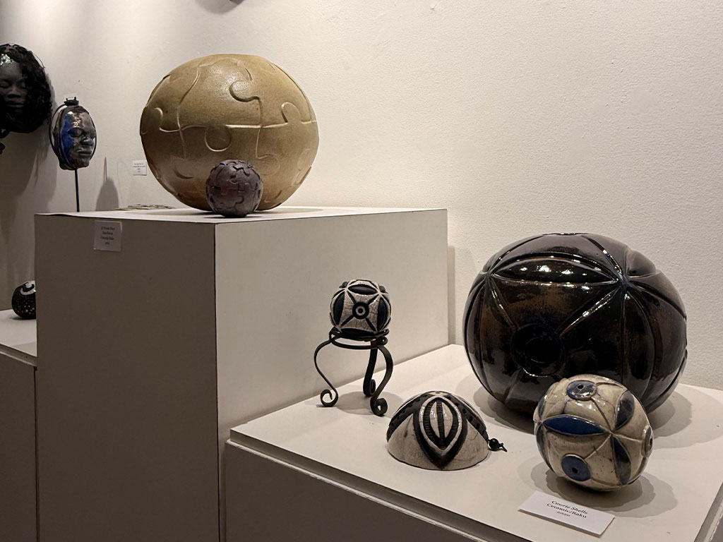 A collection of Marilyn Proctor-Givens’ spherical ceramic works is displayed as part of her “Exploration of a Process” exhibition at Florida A&M University’s Foster-Tanner Fine Arts Gallery. The exhibition showcases Proctor-Givens’ exploration of form, surface design and artistic techniques throughout her career. (Photo courtesy of Taylor Brooklyn-Cook)