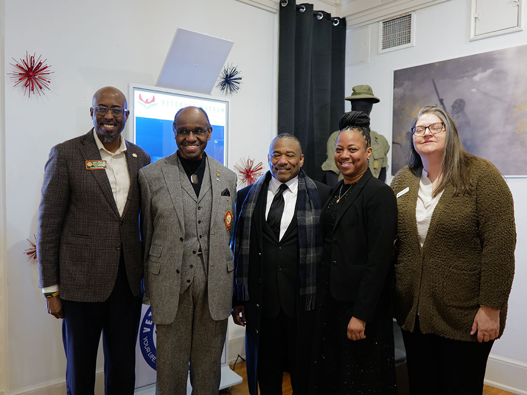 Community members gather inside the Meek-Eaton Black Archives exhibit at Florida A&M University, which showcases African American military history and service.