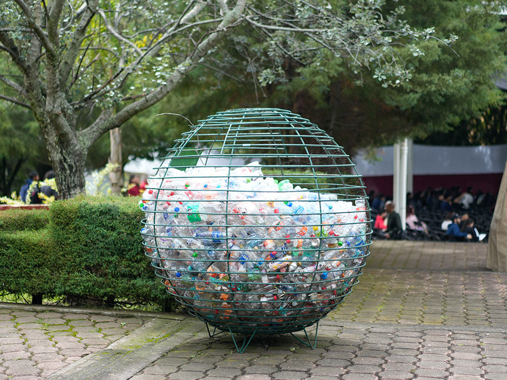 A globe-shaped collection bin filled with plastic bottles on the Instituto Tecnológico Superior de Ciudad Hidalgo campus serves as a visual reminder of the environmental challenges at the heart of the Nexus mission and the need for sustainable solutions across communities.