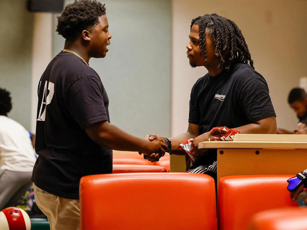 MMH two young men shaking hands
